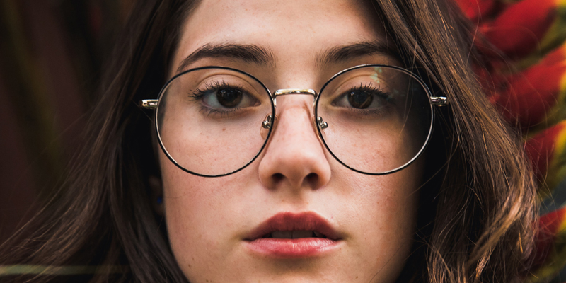 A girl wearing round glasses